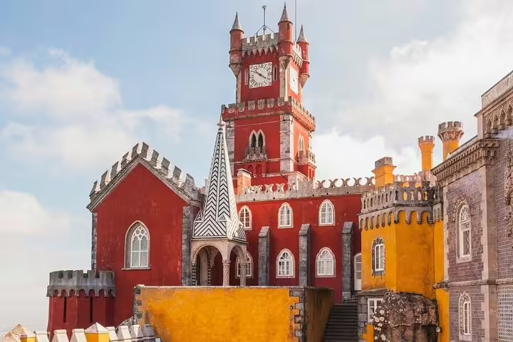 Vibrant view of Sintra's Pena Palace with its colorful architecture, a highlight of the small-group full-day tour.