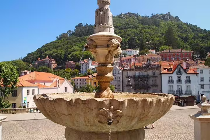 Scenic view of Sintra with historic fountain and vibrant architecture, ideal for a full-day tour including Pena Palace.