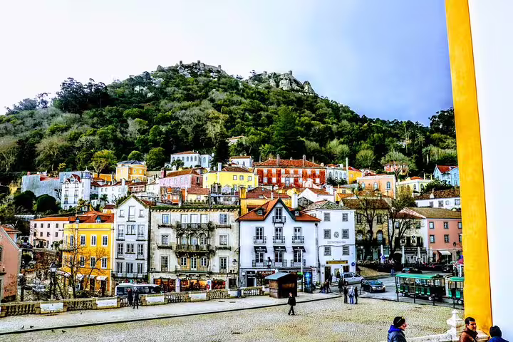 Picturesque view of Sintra's vibrant hillside architecture against lush greenery.