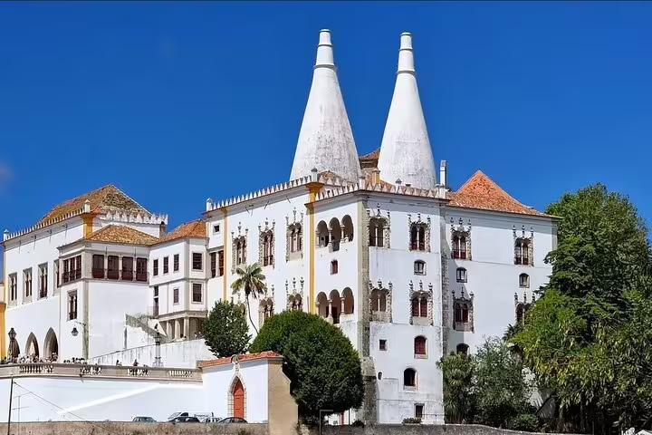 Historic Sintra National Palace under a clear blue sky, a highlight of the Sintra Mountain Guided Tour with Pena Palace and Moorish Castle.