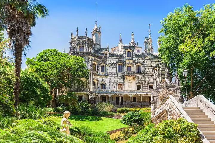 Ornate facade of a historic palace surrounded by lush gardens in Sintra, featured on the Lisbon to Sintra full-day tour.