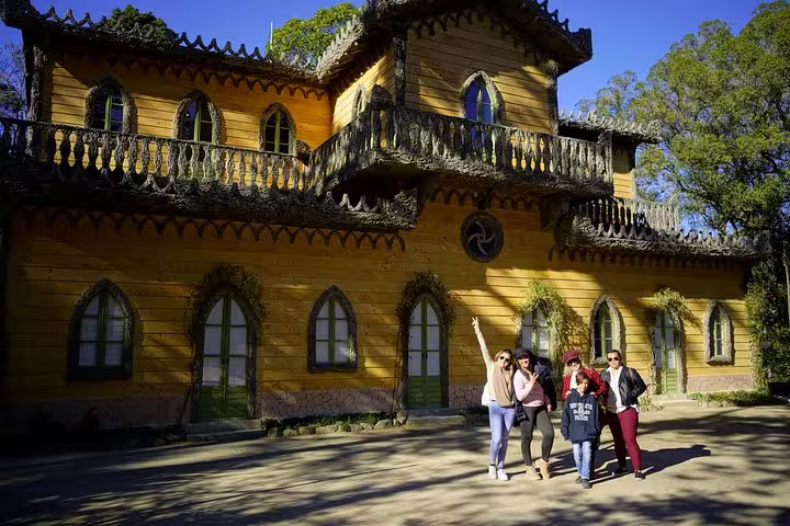 Visitors enjoy a sunny day at the picturesque Chalet da Condessa in Sintra during a full-day private tour with Pena tickets.