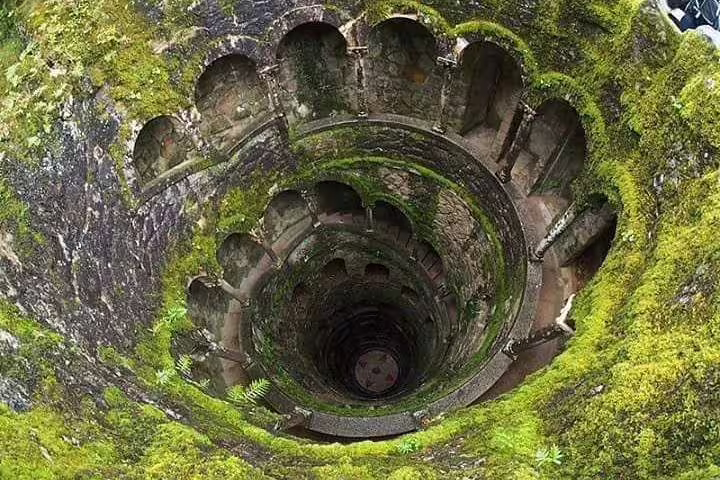Explore the enchanting Initiation Well at Quinta da Regaleira on a full-day Sintra tour including Pena Palace in a small group.