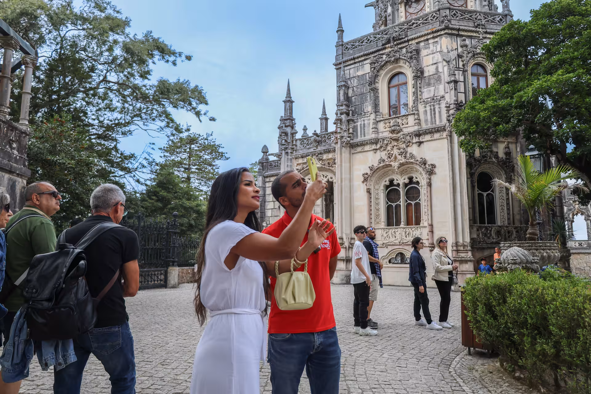 Tourists admire the ornate Gothic architecture of Quinta da Regaleira in Sintra on a guided small group tour.