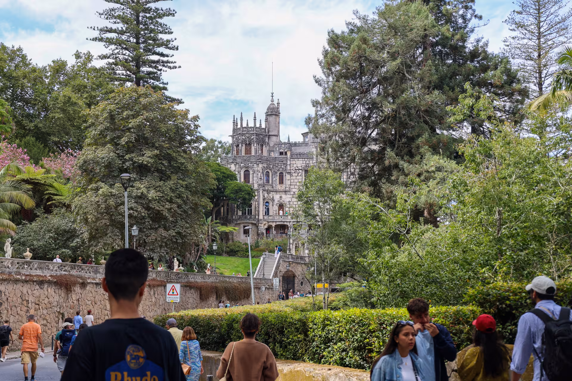 Visitors explore the lush gardens leading to the ornate Quinta da Regaleira palace in Sintra.