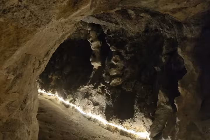 Mysterious cave interior at Regaleira Estate, illuminated by soft lighting, ideal for exploring during the Sintra tour.
