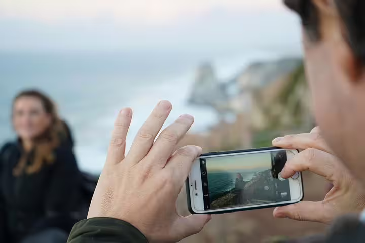 Capturing a scenic view of the Atlantic coastline during a full-day private tour of Sintra, Roca, and Cascais.