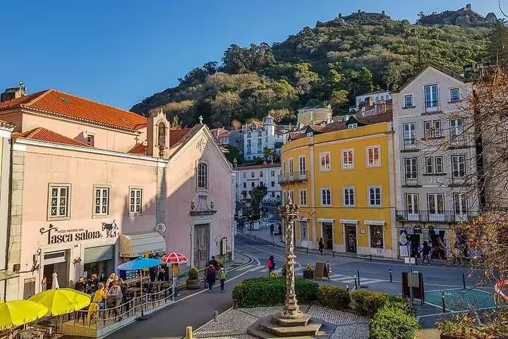 Colorful Sintra square with charming cafes and historic architecture, perfect for a scenic stop on a Pena Palace and Cascais tour.