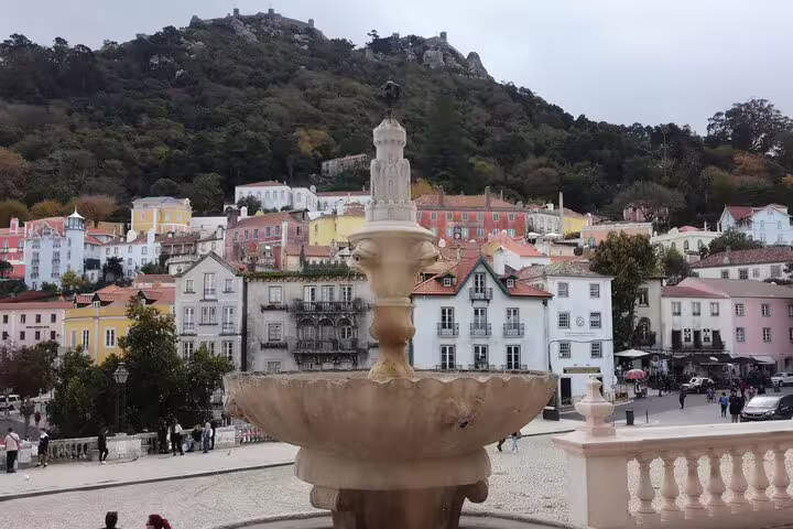 Charming Sintra town square with fountain and colorful buildings, a stop on the Fatima Sintra Tour from Lisbon.