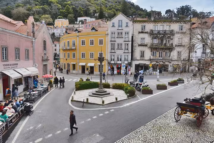 Charming town square in Sintra with colorful historic buildings and outdoor cafes, perfect for exploring on foot.