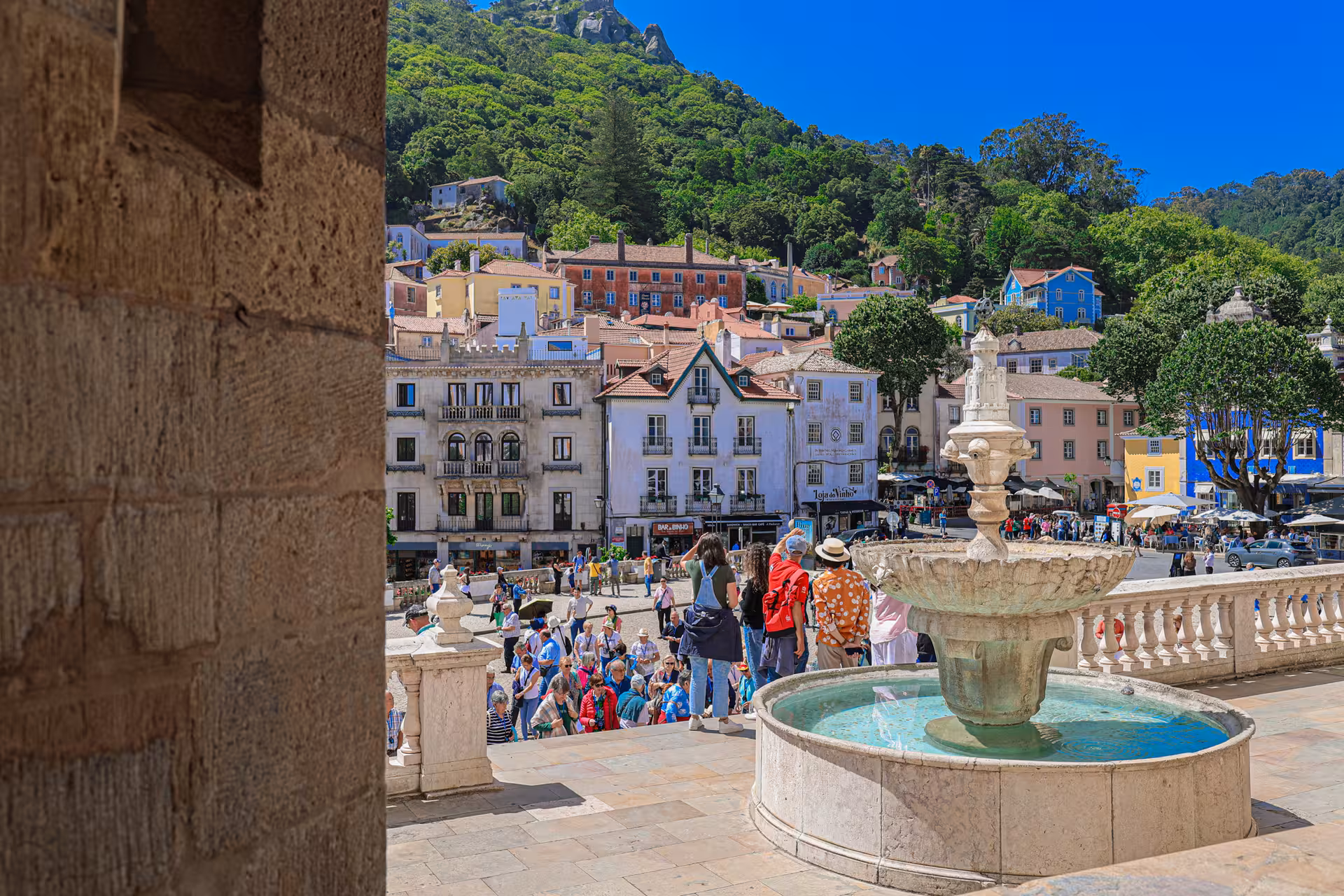 Charming Sintra town square with vibrant architecture and bustling tourists, a highlight of the Lisbon day tour.
