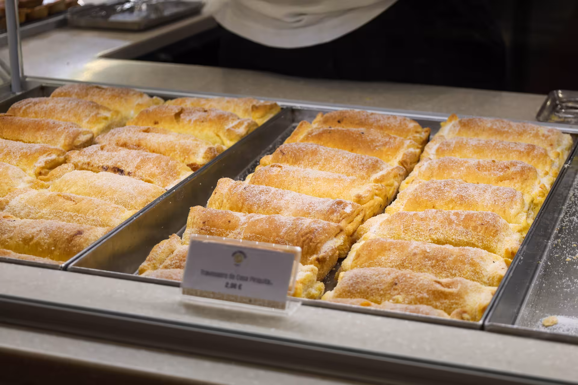 Freshly baked Travesseiros pastries on display in a Sintra bakery, a must-try on the Sintra tour.