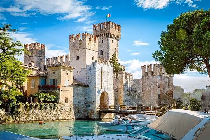 Explore Sirmione's stunning Scaliger Castle on a private day trip from Venice, offering picturesque lake views.