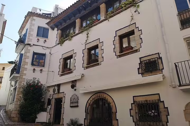 Traditional Mediterranean architecture in Sitges, showcasing charming whitewashed buildings with decorative trim.