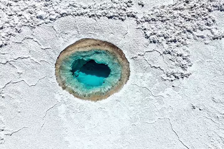 Aerial view of Siwa Salt Lakes turquoise pool and white salt flats on a 4-day private Siwa tour from Cairo