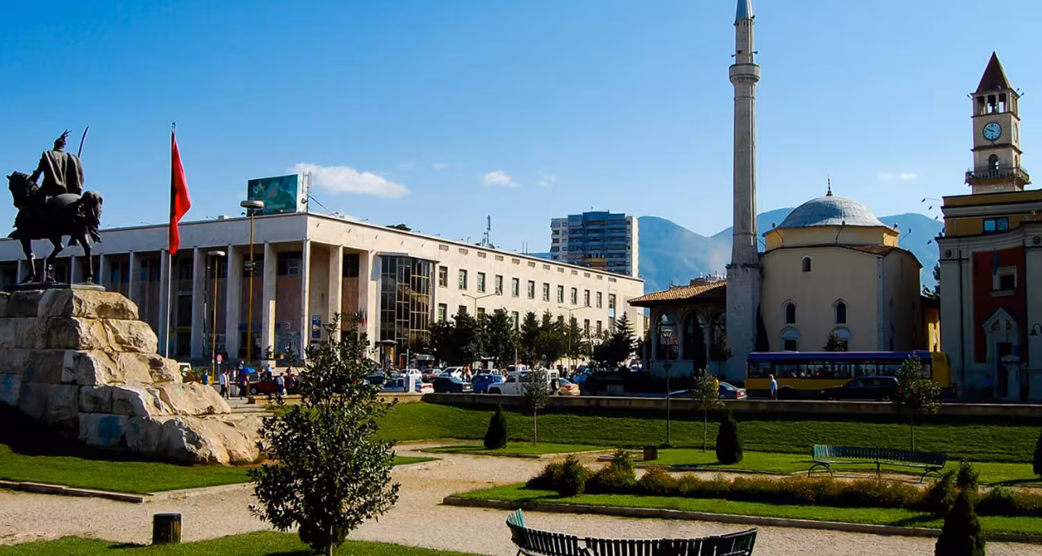 Discover Skanderbeg Square in Tirana, Albania, showcasing historic architecture and vibrant city life on the Balkan Express tour.