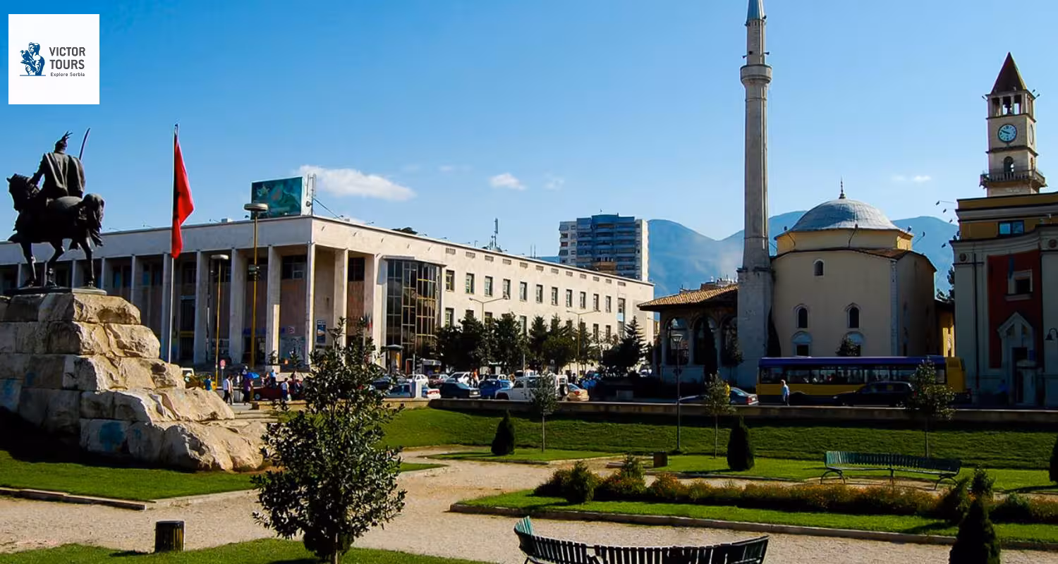 Tirana's bustling Skanderbeg Square with iconic statues and buildings, capturing Albania's vibrant culture on a Balkan tour.
