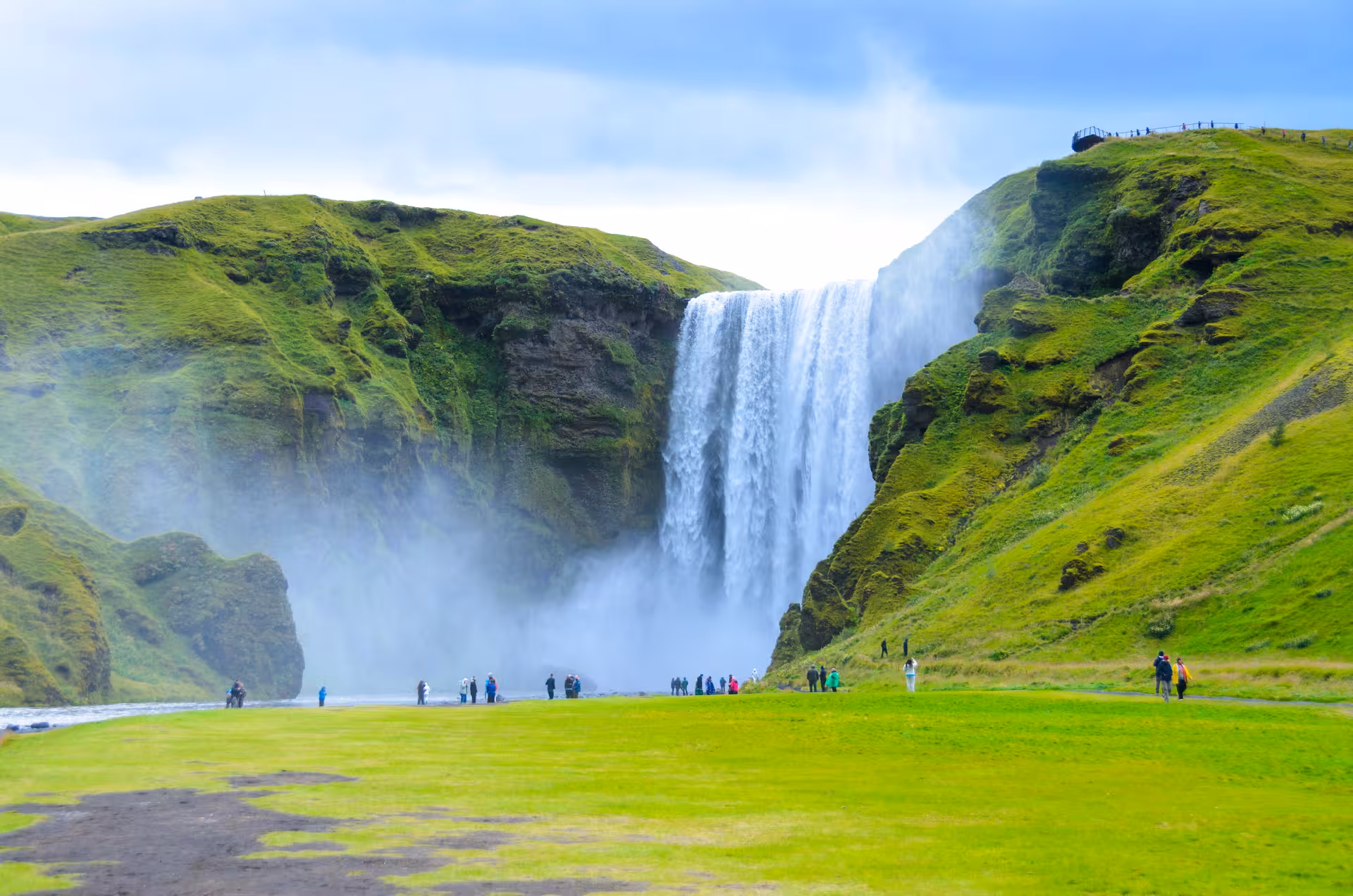 Skogafoss waterfall stop on South Coast Adventure Rally Car Edition, Iceland scenic drive with misty cliffs