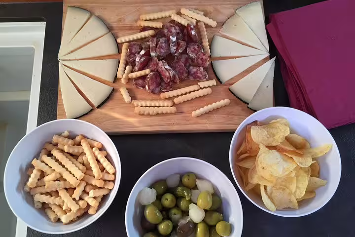 Delight in a gourmet spread of cheese, cured meats, olives, chips, and snacks on a scenic 2-hour small group cruise.