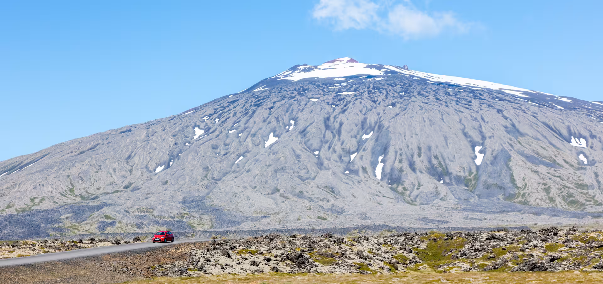 Snow-capped Snæfellsjökull volcano under clear blue skies on Snæfellsnes Peninsula, perfect for a mythical adventure.