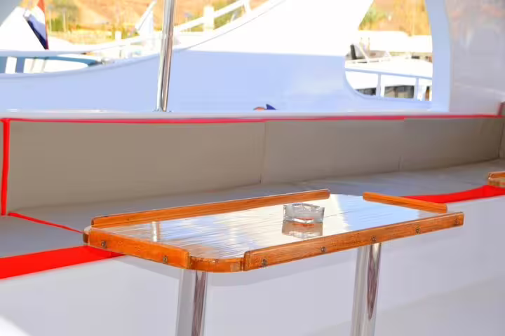 Dining table and cushioned bench on snorkel boat for Marsa Mubarak Marsa Alam trip with turtles and dugong