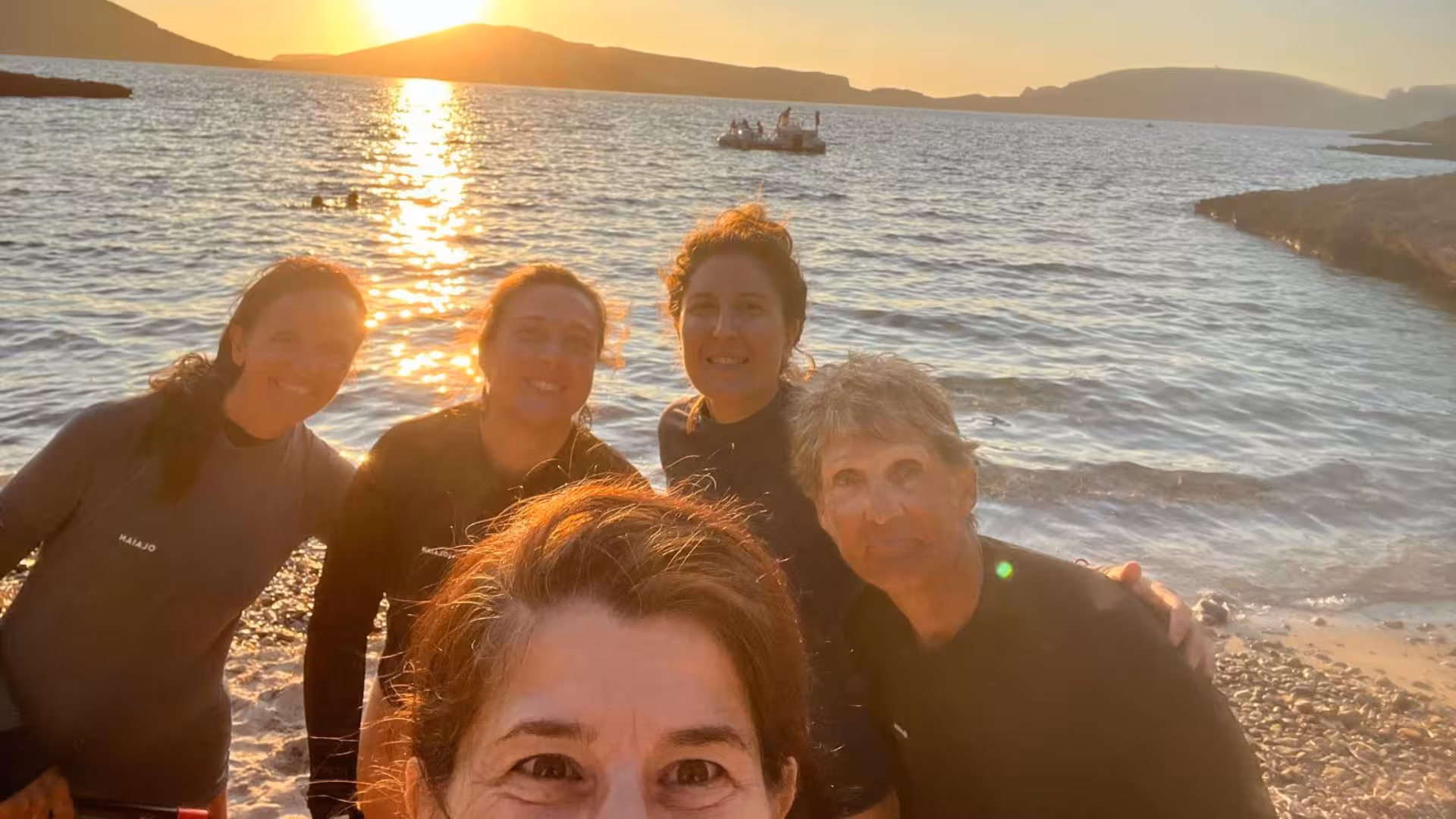 Group of snorkelers enjoying a sunset at Porto Conte Park, Alghero, perfect for a snorkeling adventure.