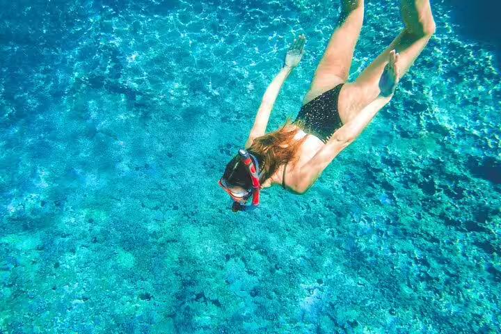 Snorkeling in the Blue Lagoon during the 3 Islands speedboat tour, exploring clear water and seabed