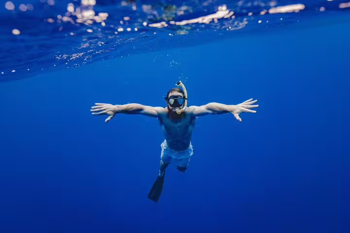 Snorkeler in clear Red Sea water on Hamata Islands trip from Marsa Alam, Egypt, exploring vibrant reefs