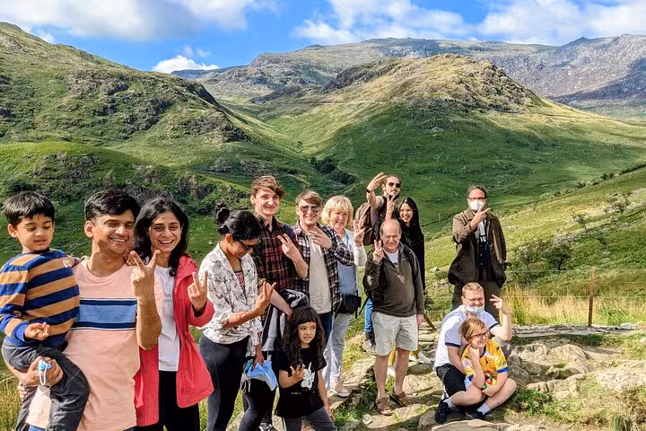 Snowdonia & The 3 Castles Tour group photo in Snowdonia National Park with green Welsh mountains behind