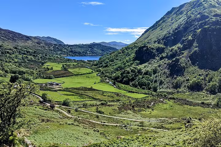 Snowdonia National Park valley view with lake and green hills, a highlight of the Snowdonia & 3 Castles Tour
