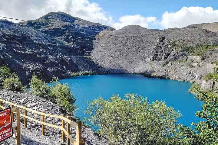 Turquoise slate quarry lake in Snowdonia, North Wales, dramatic viewpoint on the Snowdonia & 3 Castles Tour