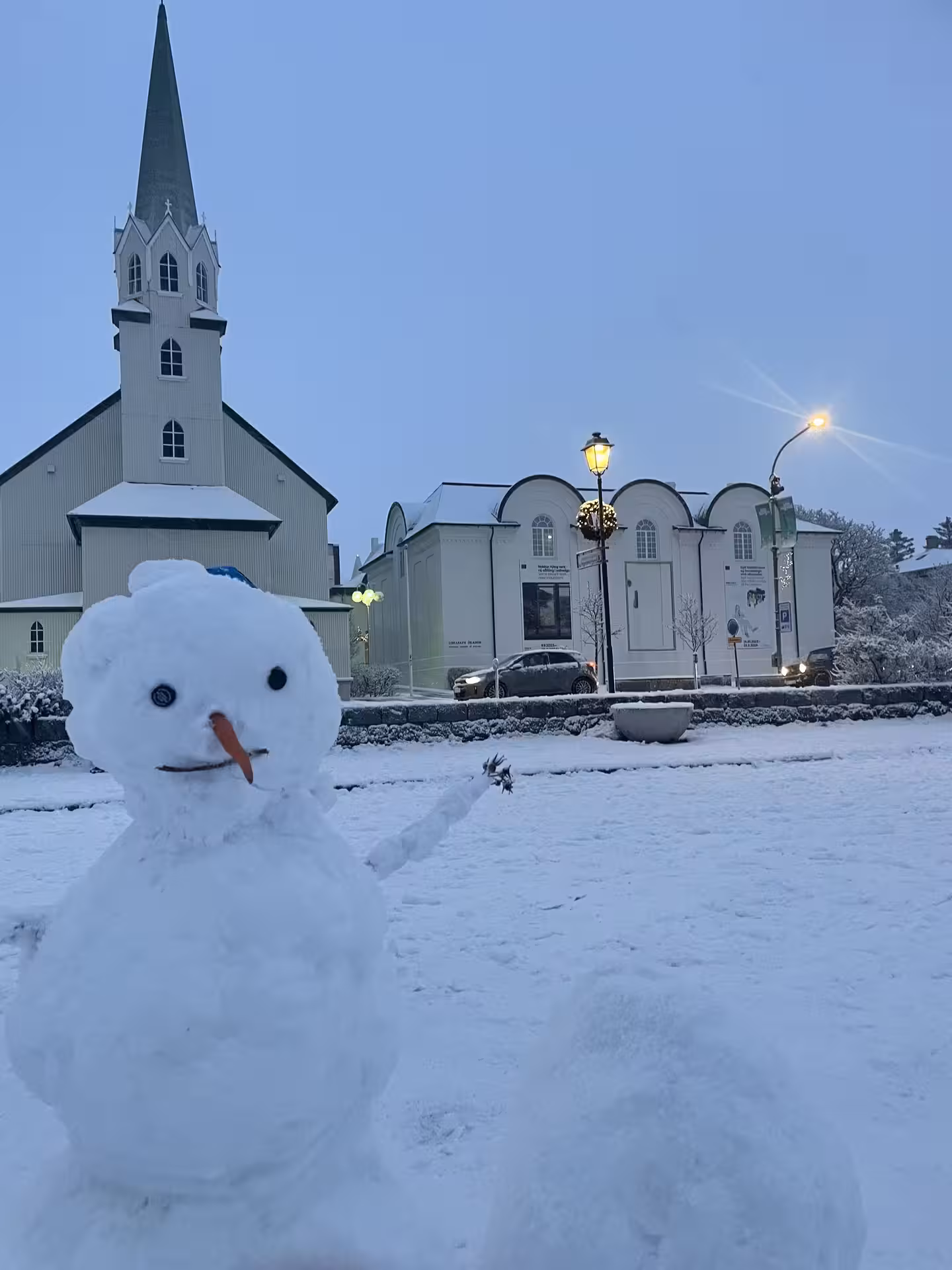 Snowman in front of a church in snowy downtown Reykjavík, part of a cultural exploration tour.