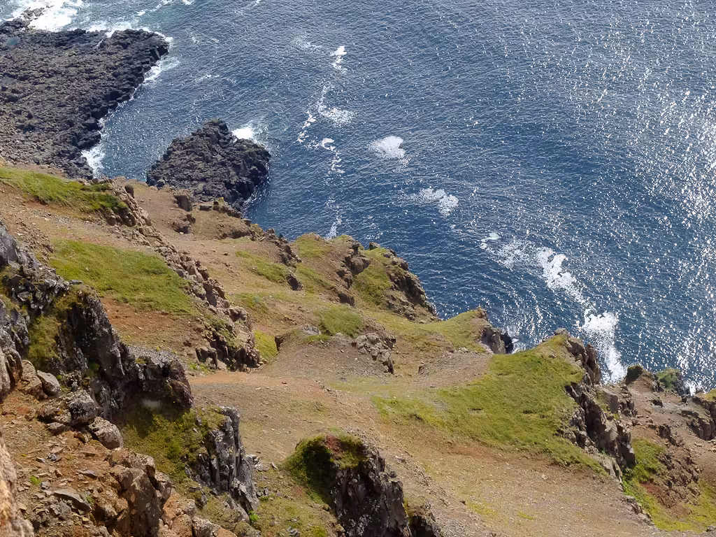 Steep sea cliffs and sparkling ocean views along the Solar Eclipse Hike route, scenic coastal trekking