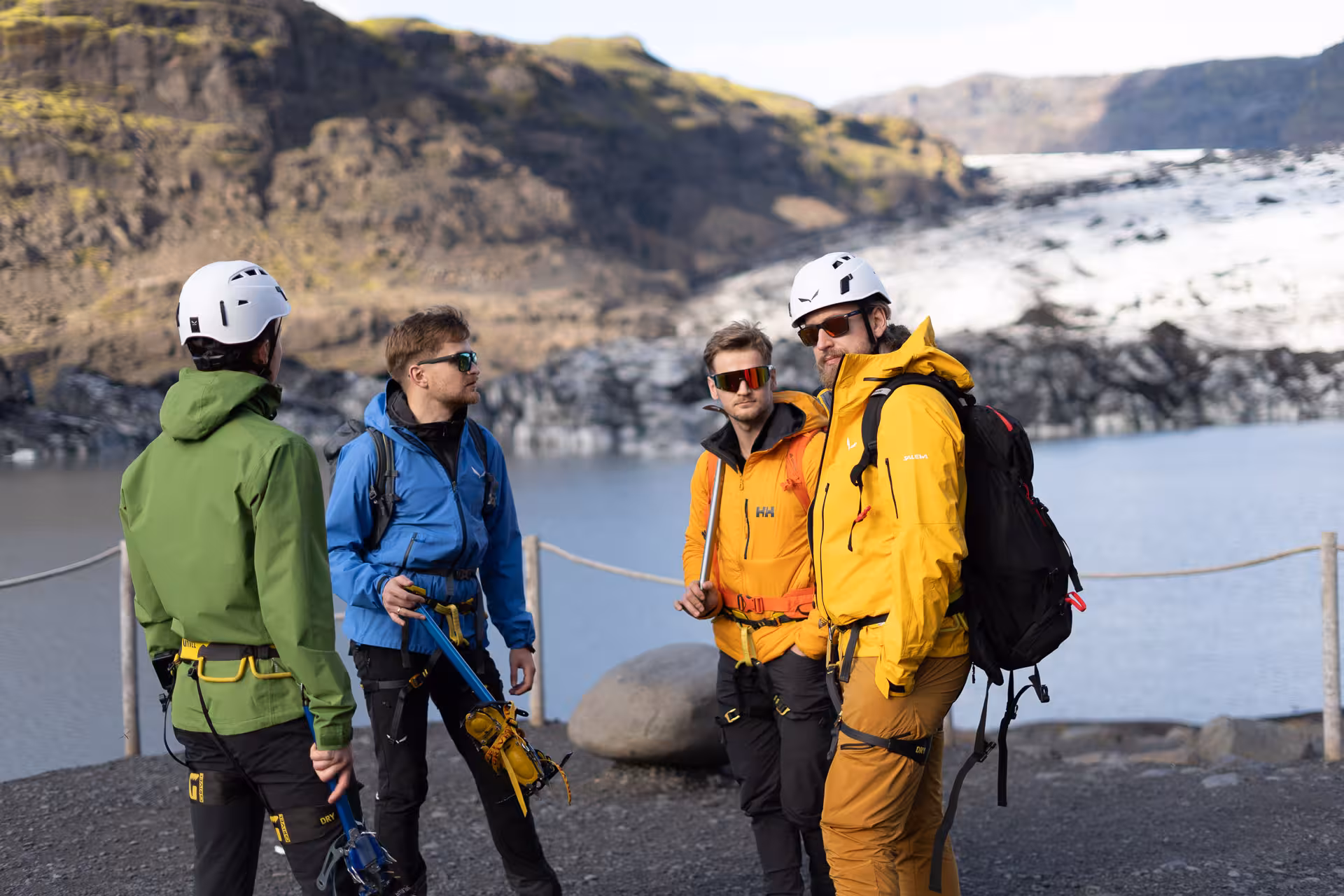 Guided group preps helmets and ice axes before Sólheimajökull glacier hike and ice climbing in Iceland