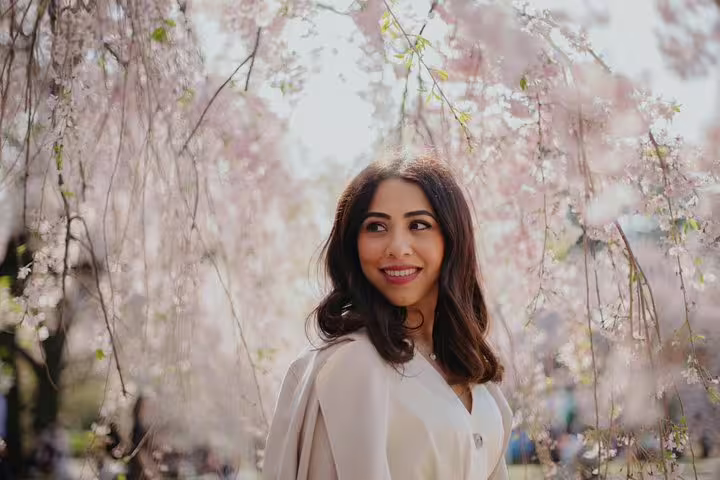 Solo portrait under Tokyo cherry blossoms in spring, captured on a personal travel and vacation photographer tour