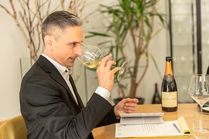 Sommelier smelling a glass of Austrian white wine during a premium Vienna wine tasting and pairing session