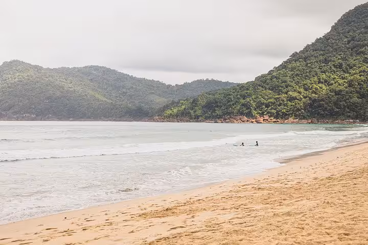 Scenic view of Sono Beach with lush green hills and gentle waves, perfect for an adventure tour by Paraty Tours.