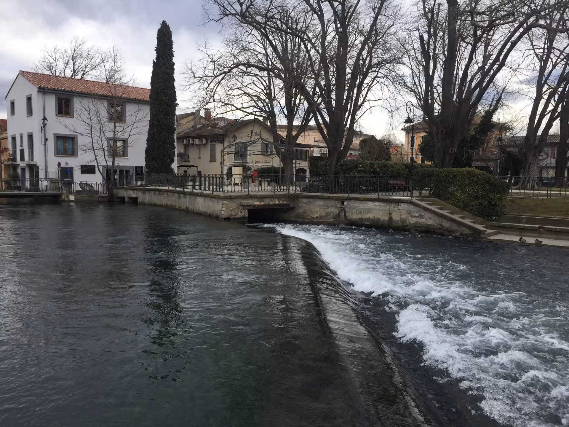 Sorgue River weir in L'Isle-sur-la-Sorgue, Provence, picturesque view on the Gordes and Roussillon day trip