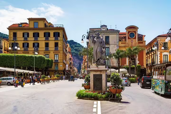Sorrento main square with statue and colorful buildings, gateway stop on Amalfi Coast VIP small group tour