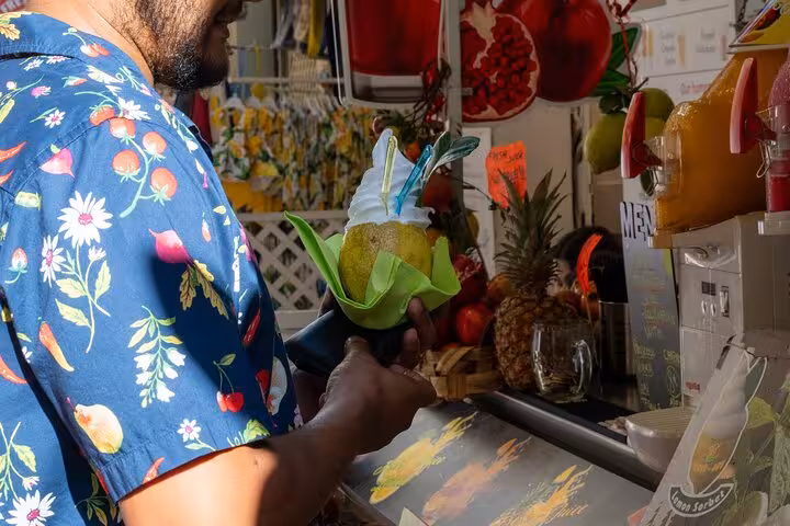 Man holding a colorful dessert at a Sorrento market stall during the Bites & Sips Tour small group experience.