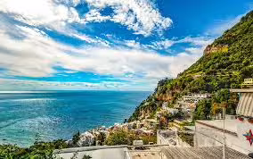Panoramic view of Amalfi Coast terraces and turquoise sea from a Sorrento boat excursion towards scenic Ieranto Bay