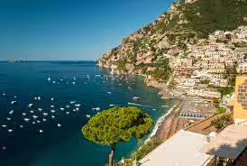 Panoramic view of Amalfi Coast village and boats on the sea, seen from a Sorrento boat tour to Positano and Ieranto Bay