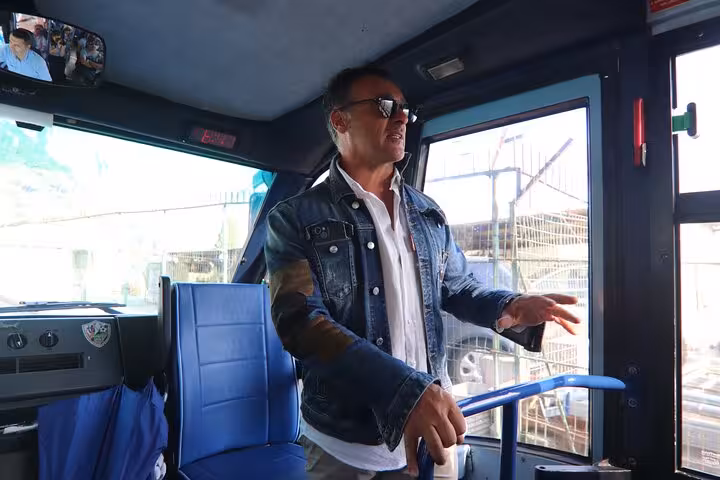 Tour guide leading a bus tour from Sorrento to Capri, highlighting key sights and attractions en route.