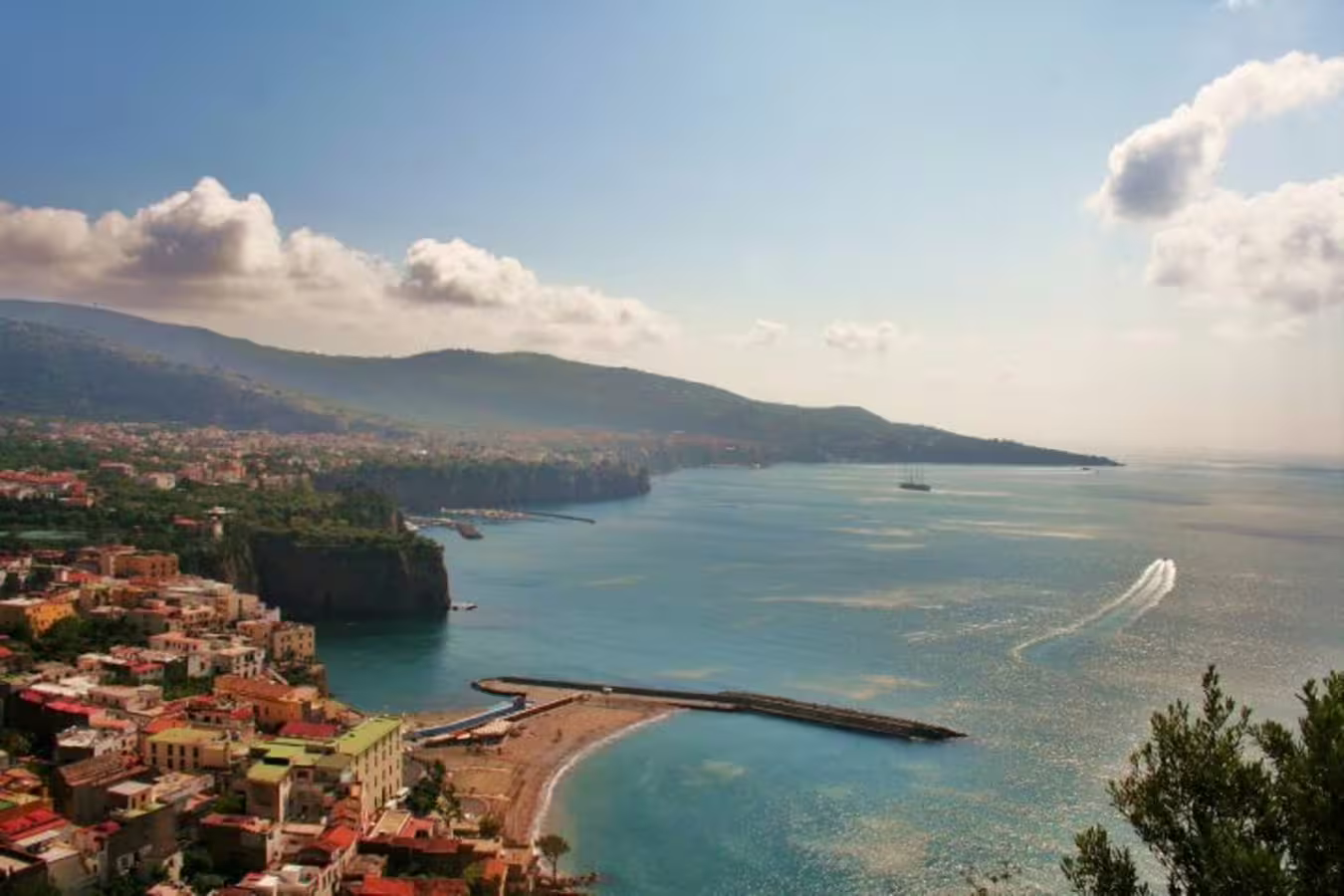 Panoramic view of Sorrento coastline and turquoise bay on a shared Amalfi Coast private boat tour from Naples, Italy
