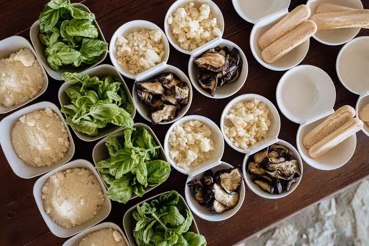 Fresh ingredients like basil, cheese, and eggplant prepared for a Sorrento cooking class with a local chef.