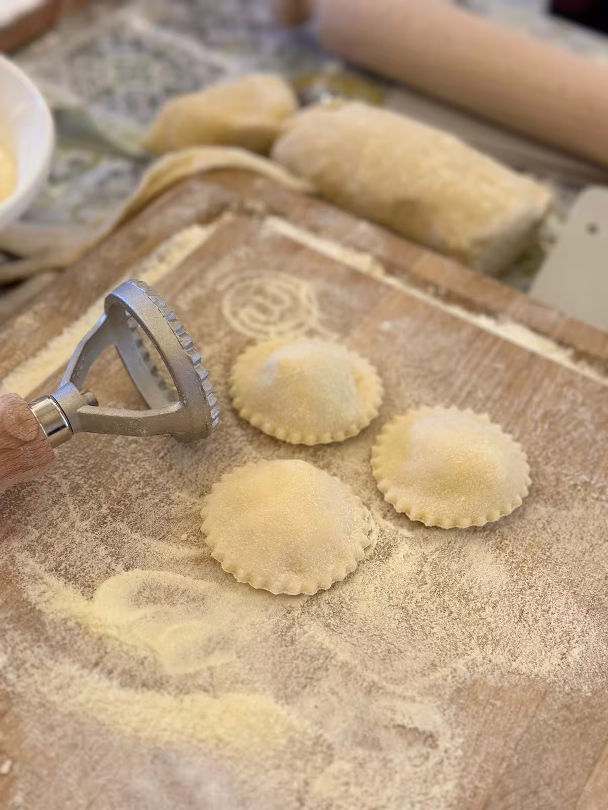Freshly made ravioli on a floured board in a Sorrento cooking class, highlighting authentic Italian pasta-making.