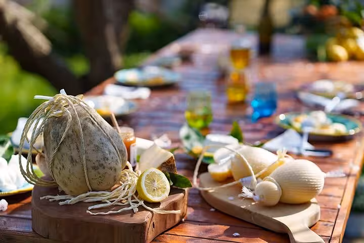 Rustic outdoor table set with fresh cheese and lemons for authentic farm-to-table pizza experience.