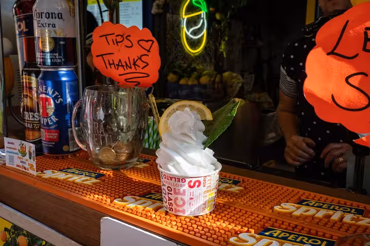 Close-up of creamy gelato with lemon slice at a Sorrento market, perfect for the Bites & Sips Tour.