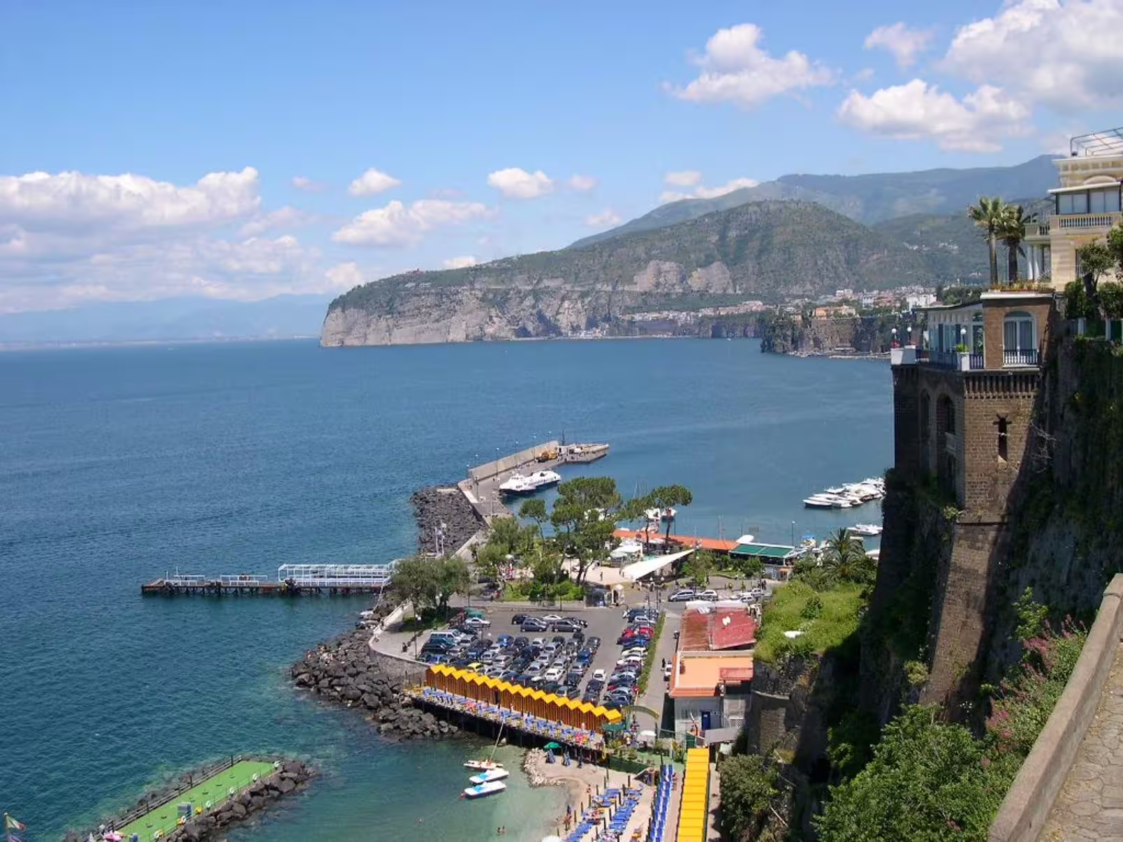 Panoramic view of Sorrento harbor and cliffs on a shared Amalfi Coast private tour with beaches, yachts and clear blue sea