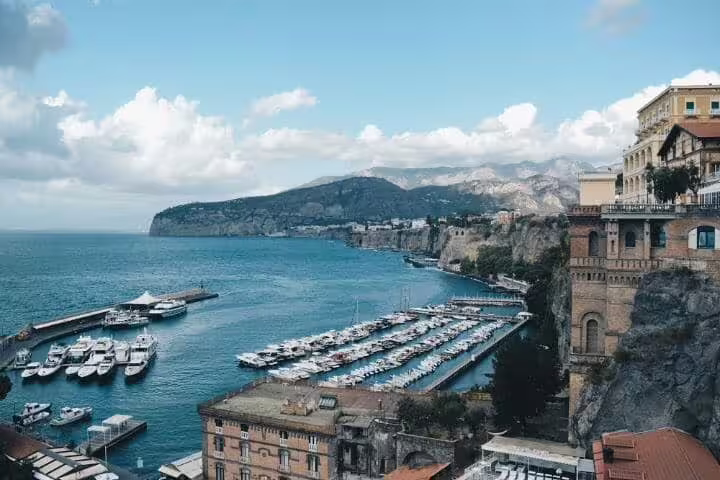 Scenic Sorrento harbor with yachts, marina and clifftop villas overlooking the Bay of Naples on a private full-day tour